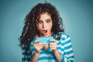 curly hair woman with phone