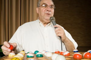 male bingo caller in bingo hall