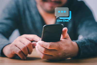 man holding phone using live chat