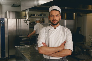 kitchen staff member wearing chefs whites in kitchen